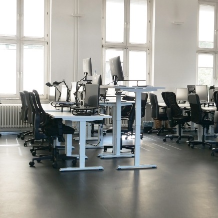 Ergonomische Büroplanung im Open Space Office mit Büromöbeln und höhenverstellbaren Schreibtischen